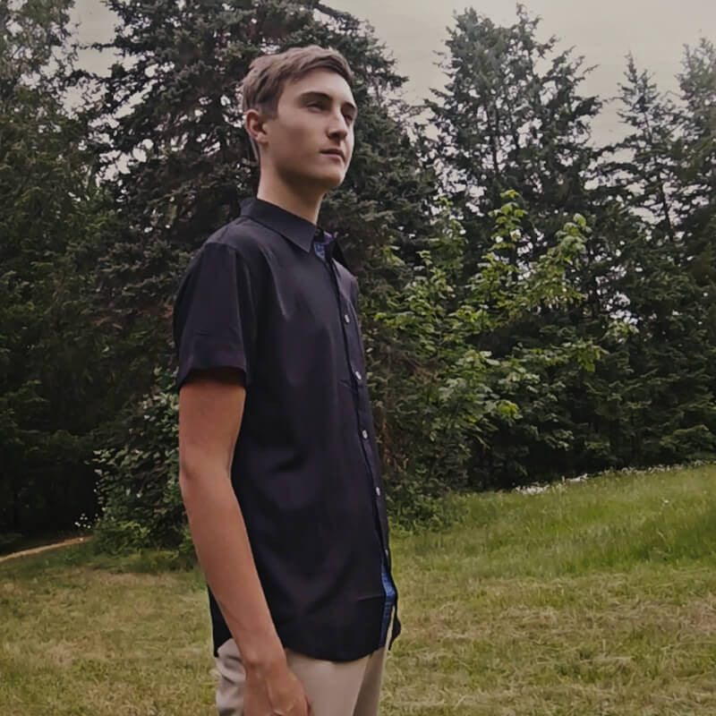 An image showing a man wearing Dude Woven Shirt from Disc Golf Apparel