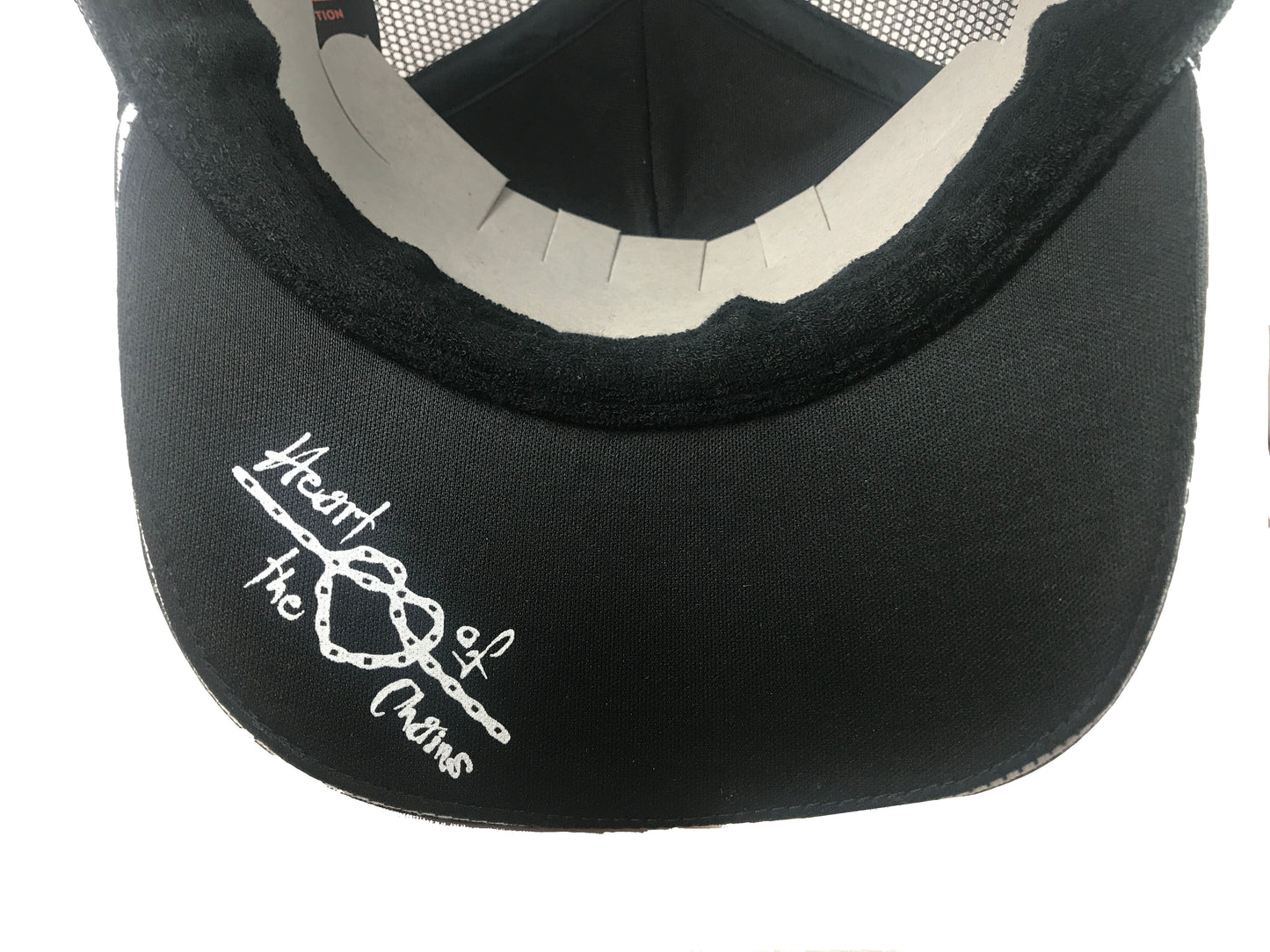 An image showing Kona Trucker Cap,  "heart of the chains" stitched underside print