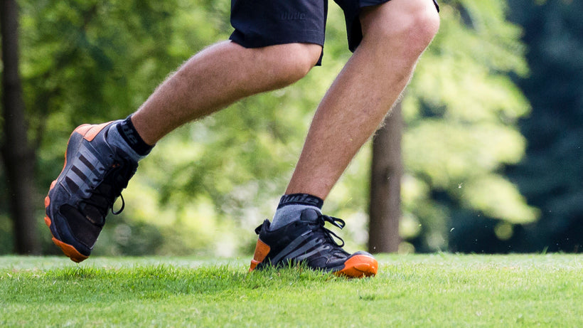 An image showing legs of a man running wearing Reversible Unstinkable Socks from Dude Apparel.