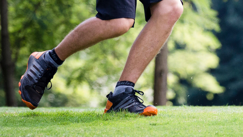 An image showing legs of a man running wearing  Reversible Unstinkable Socks from Dude Apparel. 