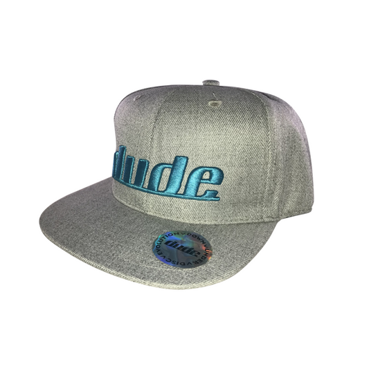 An image showing a Gray KJ Nybo flat brim hat, with signature DUDE stitching in teal color.