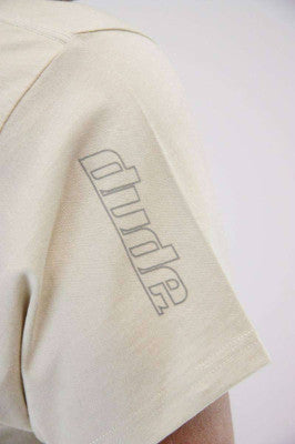 An image showing Arden Cotton Tee- Disc golf polo shirt sleeve.  Disc golf polo off white color 